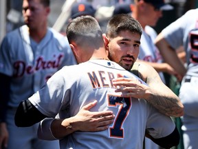 Nicholas Castellanos  says goodbye to Jordy Mercer of the Detroit Tigers in the dugout after being traded to the Chicago Cubs during the first inning against the Los Angeles Angels at Angel Stadium of Anaheim on July 31, 2019 in Anaheim, California.