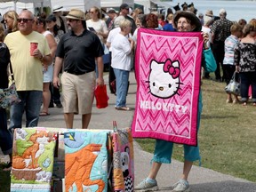 Stephanie McBride displays a hand-made quilt on Aug. 26, 2017, during that year's Art by the River event in Amherstburg.