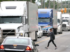 In this June 13, 2019, file photo, heavy truck traffic is shown on Wyandotte Street West, used by commercial drivers departing the Ambassador Bridge and hoping to avoid a construction zone along southbound Huron Church Road.