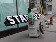 End of the week, end of an era. A worker removes the Starbucks sign from the corner of Ouellette Avenue and University Avenue in downtown Windsor on Friday, July 26, 2019..