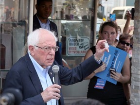 U.S. Senator and presidential candidate Bernie Sanders holds up a vial of medication after visiting The Olde Walkerville Pharmacy in Windsor on Sunday, July 28, 2019.