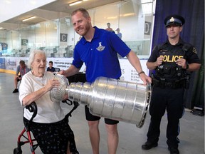 Former Windsor Spitfire Steve Ott holds the Stanley Cup for Jean Pepper after winning it as an assistant coach with the St. Louis Blues in 2019. He'll look to get back on top as a new NHL season is set to begin.