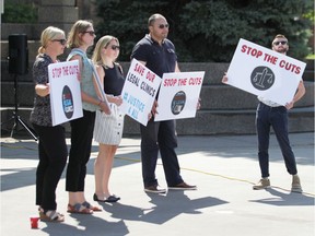 Protestors from the Windsor-Essex Bilingual Legal Clinic hold signs at Charles Clark Square on Tuesday, July 30, 2019 during a provincial day of action against cuts to Legal Aid Ontario. Lawyers from the group are concerned the $133 million in cuts will prevent low income clients from accessing legal council.