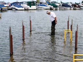Lakeshore Mayor Tom Bain inspects the submerged dock at Belle River Marina boat ramp Wednesday Jul 31, 2019. Lakeshore Council voted to increase the height of the dock and the boat ramp will remain open to boaters throughout the construction.