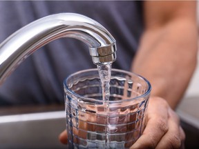 Filling a glass with tap water.