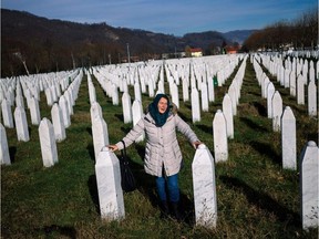 A woman mourns over a relative's grave at the memorial centre of Potocari near Srebrenica on Nov. 22, 2017. United Nations judges that day sentenced former Bosnian Serbian commander Ratko Mladic to life imprisonment after finding him guilty of genocide and war crimes in the brutal Balkans conflicts over two decades ago.