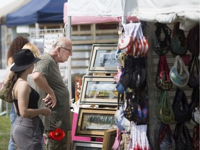 Art lovers face the hot temps as they browse the vendors at the Art by the River in Amherstburg, Sunday, August 26, 2018.