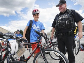 Owner of a fine new set of wheels, Noah Bradatanu, 12, was all smiles as he checked out his new bike with Windsor police Const. Jeff Tremblay on July 11 at the end of a week's fun at Camp Brombal, where 41 local 10- to 12-year-olds were guests of the Windsor Police Service. The students, chosen from the Values, Influences, and Peers school program in Windsor and Essex County, returned to the Windsor Police Service Training Facility in Windsor on Thursday, with each receiving a new bike, helmet, lock and backpack full of school supplies.