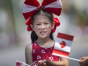 Claire Laio, 5, enjoys the Canada Day Parade on Ouellette Avenue., while decked out in red and white Canada attire, Monday, July 1, 2019.