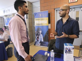 University of Windsor student Shahid Hamid, left, chats with Emad Cheraghi of the Institute of Electrical and Electronics Engineers at the Canadian Undergraduate Computer Science Conference at the University of Windsor on July 25, 2019.