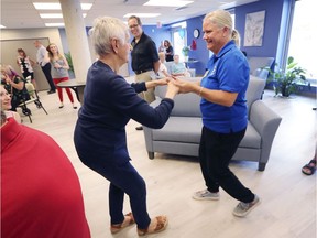 Grand opening. Katarina Kauric, left, a participant in the new Daybreak at the Lodge program at Windsor's Huron Lodge, dances with caregiver Denise D'Ascanio on July 4, 2019, during the official opening of a program that is a partnership with the Alzheimer Society of Windsor and Essex County.