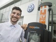 Kevan Borges, a sales representative at Volkswagen of Windsor, is pictured next to a newly installed electrical vehicle charger, Thursday, July 18, 2019.