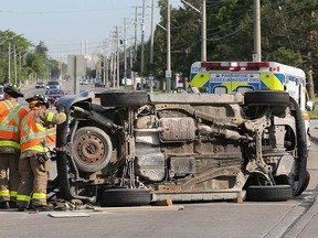 A SUV rests on its driver side at the intersection of Lauzon Road and Tranby Avenue after a collision with an Essex-Windsor EMS ambulance on the morning of July 26, 2019.