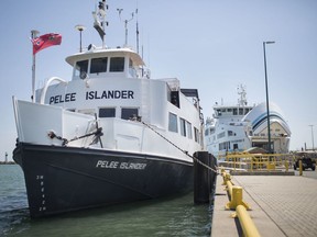 The Pelee Islander, left, the only ferry left working after both the Pelee Islander II and Jiimaan ferries were put out of commission due to mechanical issues, takes on passengers before departing for Pelee Island, Monday, July 1, 2019.