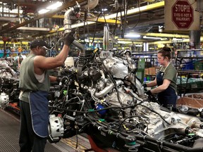 FILE PHOTO: General Motors assembly workers work on the chassis of Chevrolet 2019 heavy-duty pickup trucks at General Motors Flint Assembly Plant in Flint, Michigan, U.S. February 5, 2019.