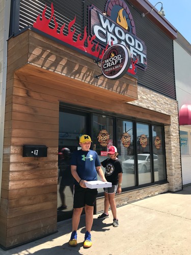 Woodcraft Pizza and Bar is fast-becoming a favorite of young and old alike since opening in April 2018. Seen here, Myles and Mackenna Michalski carry leftovers home after the first tasting.