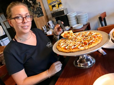 Krista Brenko, owner, prepares to dish a slice of her self-created Cheeseburger Pizza, just one of dozens of unique offerings she regularly cooks up at her Brenko's House of Pizza.