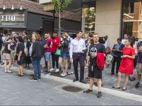 People gather across the street from Yorkville's Hazleton Hotel in the hopes that Kawhi Leonard may be inside, in Toronto, Ont. on Wednesday July 3, 2019.