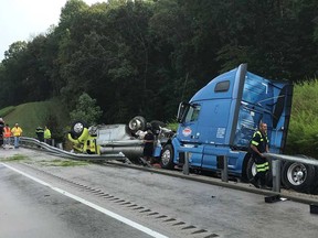 Emergency responders deal with a collision between a transport truck and a firefighting vehicle on Interstate 65 near Munfordville, Kentucky, on the evening of July 30, 2019.