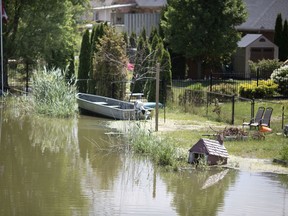 In this July 11, 2019, photo, homes along Duck Creek in Belle River are shown experiencing flooding as high water levels inundate Lake St. Clair tributaries.