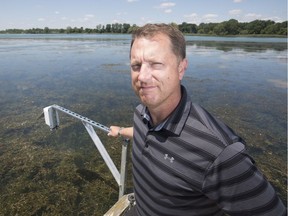 New eyes on rising river. Trevor Pitcher, director at the Freshwater Restoration Ecology Centre, is shown next to a water level monitor on the Detroit River in LaSalle on July 11, 2019.