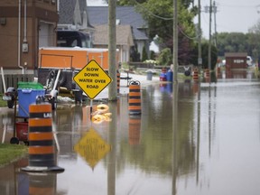 This file photo from July 10 shows signs on warning drivers of flooding over the road on Senator Street in LaSalle.