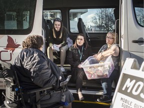 Colleen Renaud, left, talks with members of the Mobile Outreach and Support Team (MOST), from left, Stephanie Hill, Shayna Samson, and Sue LaButte, that was parked at the corner of University Ave. East and Glengarry Ave., Wednesday, April 3, 2019. There were almost 850 visits to the MOST van between February and April.