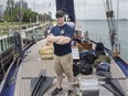 Lieut. Kirk Lapointe, executive officer of the H.M.C.S. Oriole, the oldest commissioned ship in the Royal Canadian Navy, is pictured with the ship as it docks at Dieppe Park, Friday, July 19, 2019.