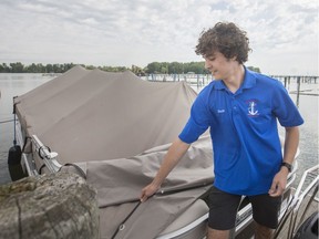 Sam Letwin, a City of Windsor marine attendant at Lakeview Park Marina, removes the tarp on the pontoon boat used to ferry people to and from Peche Island, Tuesday, July 2, 2019.