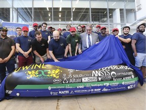 A team of University of Windsor and St. Clair College students, with their professors at the Ed Lumley Centre for Engineering Innovation at the university, are shown July 5, 2019, unveiling their hyperloop entry ahead of the SpaceX competition in California, aimed at developing high-speed technology with the potential to revolutionize mass transit.