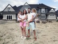 "Feels like you're living in the country." Kelly and Larry Schroth and their girls Charlotte, 3, and Lyla, 5, are shown on July 4, 2019, in front of their house that is under construction on Roseland Drive next to the city golf course. Many of the neighbourhood's smaller and more modest original homes are being levelled to make way for large, executive-style houses.