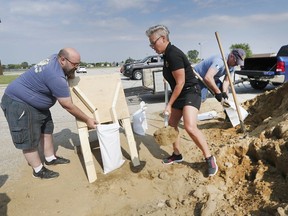 With flooding a major concern, Lakeshore is asked residents to stop watering their lawns. In this July 10, 2019, file photo, Lakeshore resident Roderick White, left, gets a hand filling sandbags from Jennifer Poisson and Shawn Brazil at the former Belle River Arena as members of the Essex county O.P.P. auxiliary unit and Lakeshore Police committee were helping with the flood prevention effort.