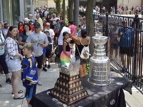 The Stanley Cup sits at the corner of Lochiel and Christina streets in Sarnia Friday afternoon, thanks to cup-winning general manager Doug Armstrong. For $5 Sarnia residents could take pictures beside the coveted trophy with proceeds going toward local minor league hockey.
