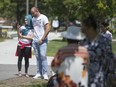 Members of the Bosnian community pay their respects during a ceremony marking the Srebrenica Genocide at the Srebrenica monument at Jackson Park on July 13,  2019.