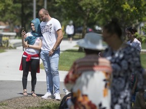 Members of the Bosnian community pay their respects during a ceremony marking the Srebrenica Genocide at the Srebrenica monument at Jackson Park on July 13,  2019.