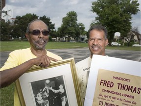 Greg Thomas, left, and Keenan Thomas, son and nephew of the late Fred Thomas, are pictured with memorabilia at Fred Thomas Park in downtown Windsor, Tuesday, July 16, 2019.