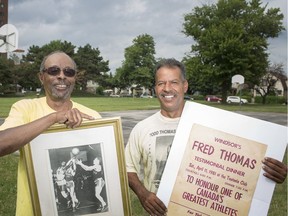 Greg Thomas, left, and Keenan Thomas, son and nephew of the late Fred Thomas, are pictured with memorabilia at Fred Thomas Park in downtown Windsor, Tuesday, July 16, 2019.