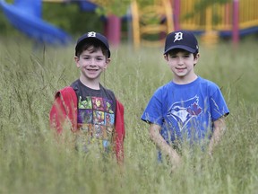 In this June 13, 2019, photo, two boys are shown deep in the grass in Riverside's Tranby Park which had been too wet for city crews to cut.