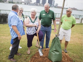 Katharine Smyth, centre, president of the Ontario Horticultural Association, is joined by Dennis Flanagan, Margaret Laman, Charles Freeman, and Jary Terryberry, during a commemorative tree planting event at Dieppe Park for the association's annual general meeting, Thursday, July 18, 2019.