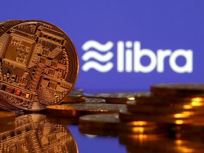 FILE PHOTO: Representations of virtual currency are displayed in front of the Libra logo in this illustration picture, June 21, 2019.