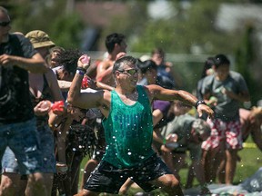 Water balloon warriors joyfully participate in the 2015 Spotted in Windsor Water Balloon Fight at Lanspeary Park.