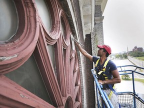 Lofty reno job. Jose Cerdas-Suarez, of Student Works Painting, works high above the street at the former Our Lady of the Rosary Church in Ford City on July 25, 2019. Now operating as the Water's Edge Event Centre, the historic building at RIverside Drive East and Drouillard Road is undergoing extensive exterior restoration work.