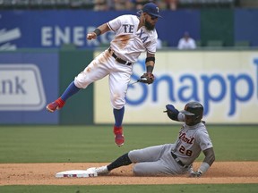 Rougned Odor  of the Texas Rangers catches a wide throw as Niko Goodrum of the Detroit Tigers slides safely into second base during the seventh inning at Globe Life Park in Arlington on August 4, 2019 in Arlington, Texas. The Rangers won 9-4.