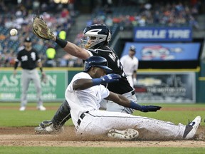 Travis Demeritte of the Detroit Tigers beats the throw to catcher James McCann of the Chicago White Sox to score from second base on a single by Jake Rogers during the second inning at Comerica Park on August 5, 2019 in Detroit, Michigan.