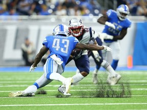 DETROIT, MI - AUGUST 08: Maurice Harris #82 of the New England Patriots makes a catch for the first down and is tackled by Will Harris #43 of the Detroit Lions during the preseason game at Ford Field on August 8, 2019 in Detroit, Michigan.