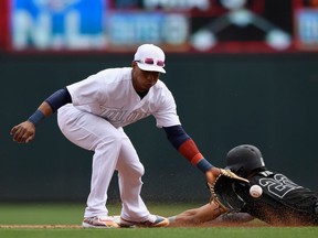 Victor Reyes of the Detroit Tigers steals second base against Jorge Polanco of the Minnesota Twins during the third inning of the game on August 25, 2019 at Target Field in Minneapolis, Minnesota.   Teams are wearing special color schemed uniforms with players choosing nicknames to display for Players' Weekend.