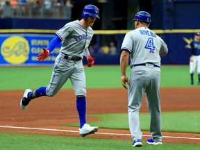Derek Fisher #20 of the Toronto Blue Jays is congratulated after hitting a two run home run in the sixth inning during a game against the Tampa Bay Rays at Tropicana Field on August 07, 2019 in St Petersburg, Florida.