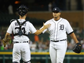 Joe Jimenez #77 of the Detroit Tigers celebrates a 3-2 win over the Seattle Mariners with Jake Rogers #34 at Comerica Park on August 14, 2019 in Detroit, Michigan.