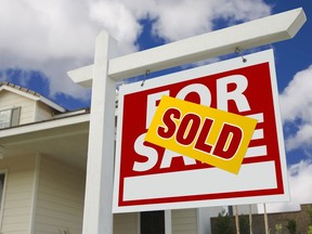 A sold sign in front of a house.