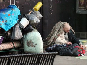 In this Dec. 12, 2018, file photo, a Windsor homeless man stakes out his downtown spot on Ouellette Avenue, his possessions parked next to him in an overflowing grocery cart.